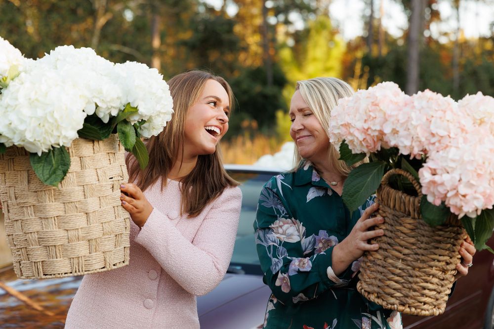 A series of romantic outdoor wedding moments with soft pink and white floral arrangements and woven baskets.