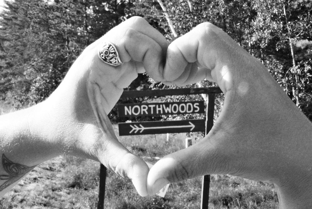 Heart with hands with Camp Northwoods sign and Thunderbird ring 
 Camp Northwoods Mason Wisconsin