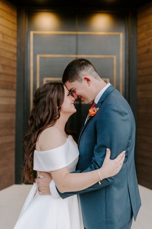 A romantic wedding sequence shows a couple in blue suit and white dress sharing intimate moments against a wooden wall.