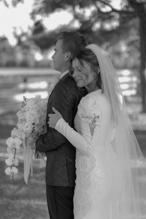 Black and white wedding photo series showing romantic moments between newlyweds in an outdoor garden setting.