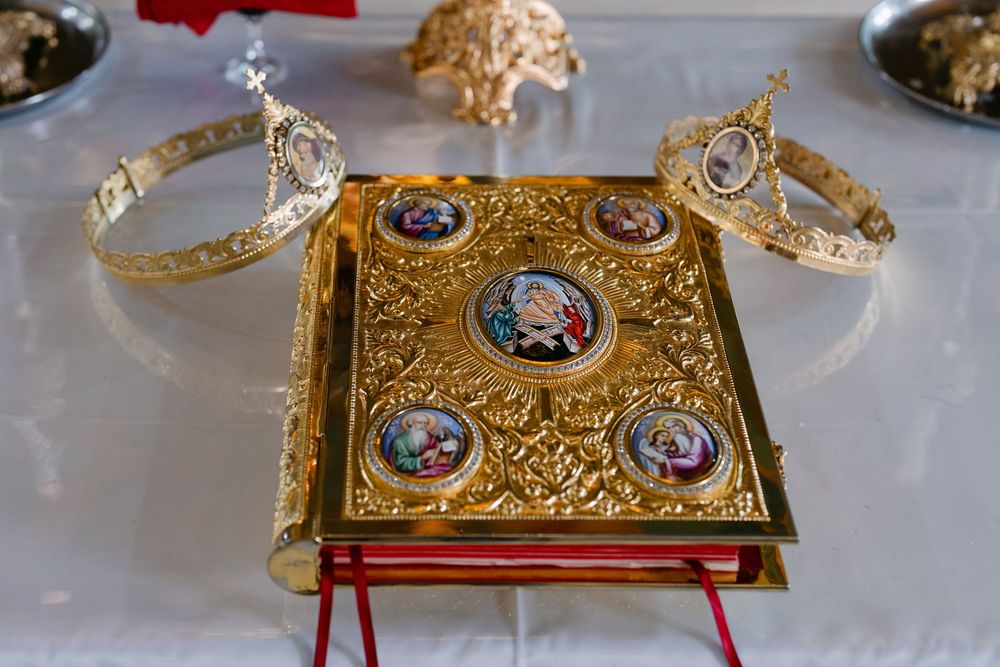 Ornate golden Orthodox Gospel book with decorative metalwork and religious medallions displayed in multiple angles.