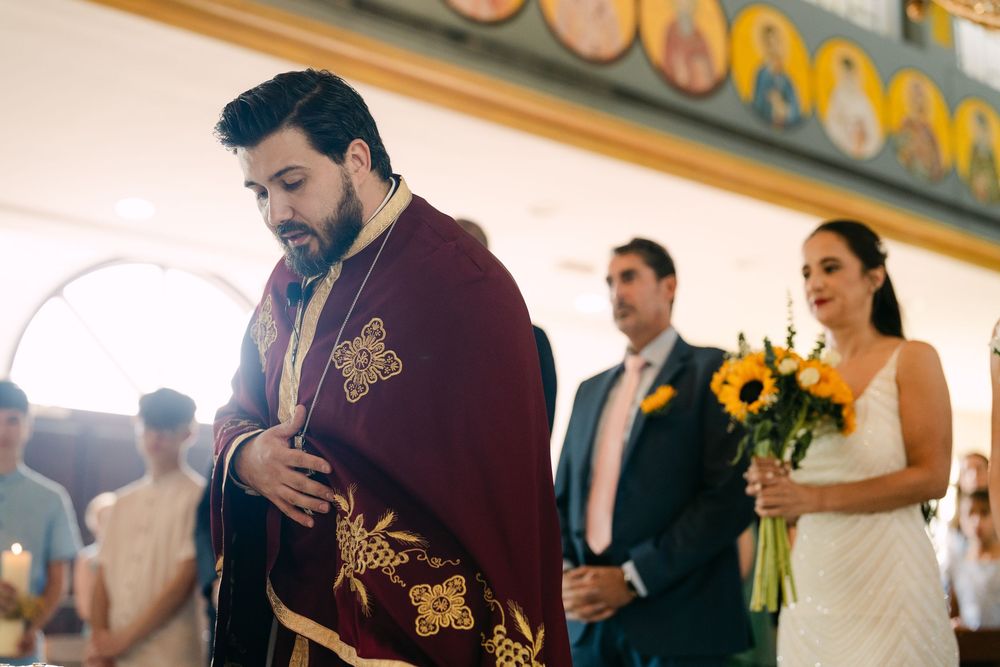 Wedding party members in burgundy attire gather together during a celebration.