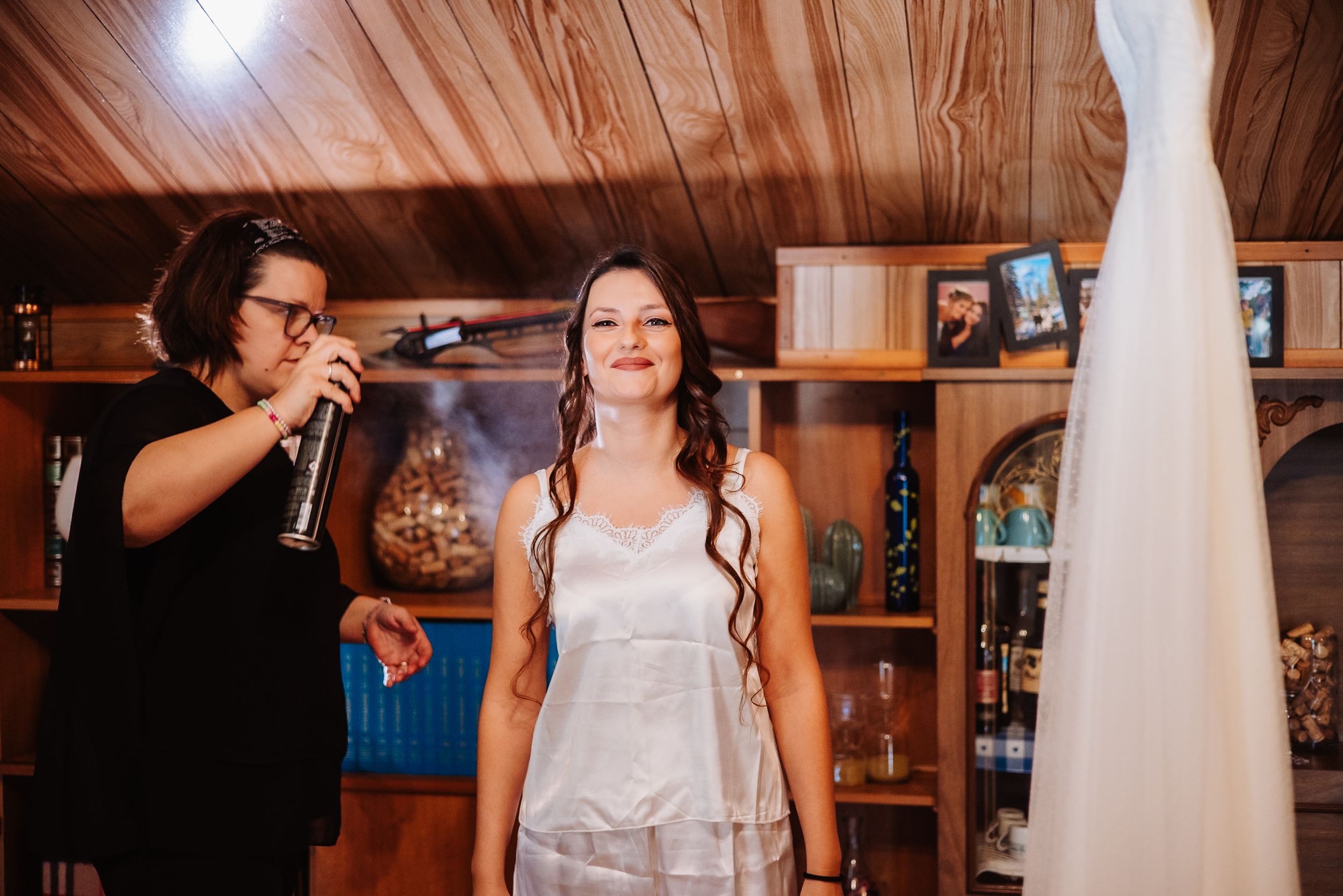 A series of wedding preparation moments captured in a rustic wooden cabin setting with white dress details.