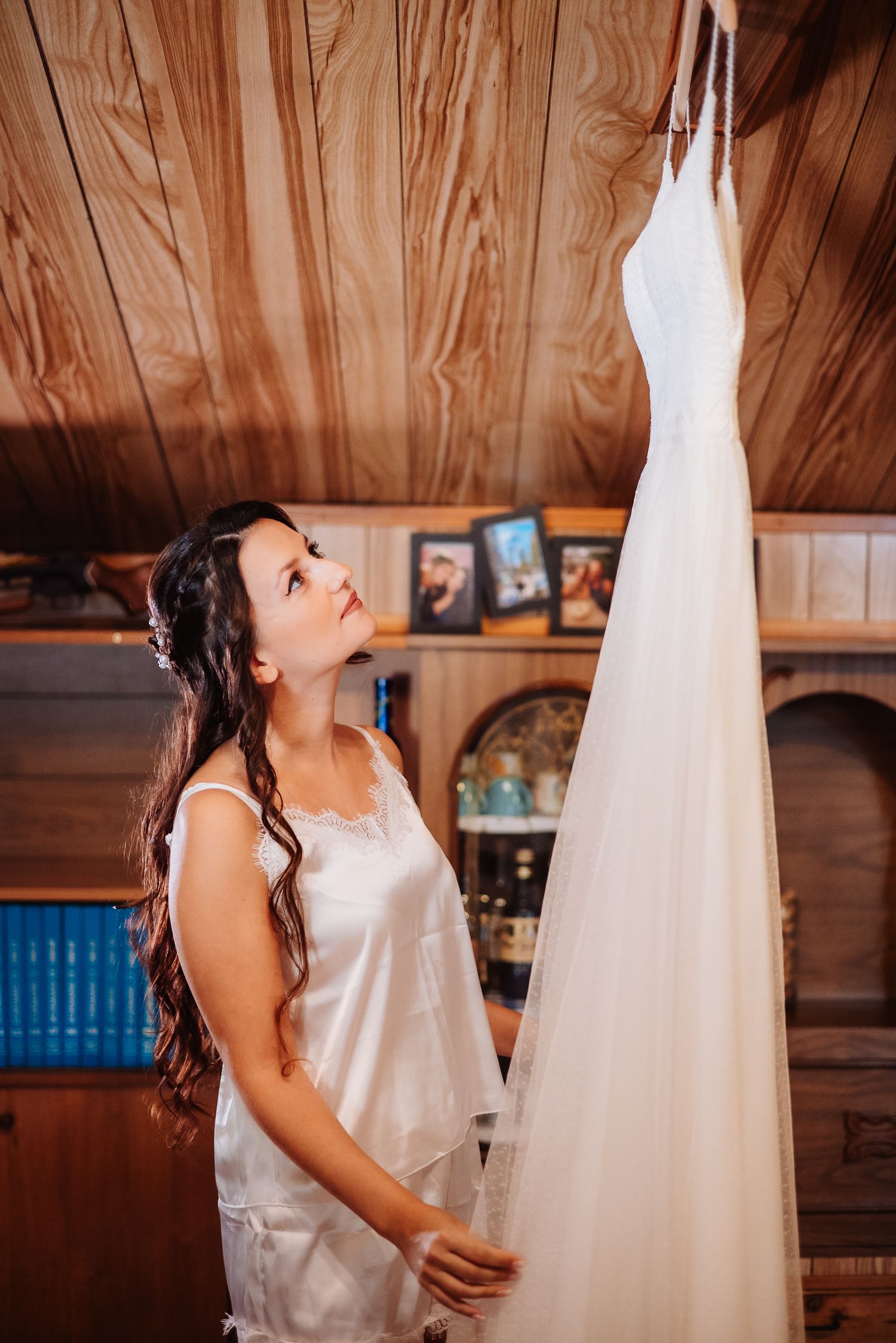 A sequence of photos shows someone in white clothing interacting with a hanging white dress in a rustic wood-paneled room.