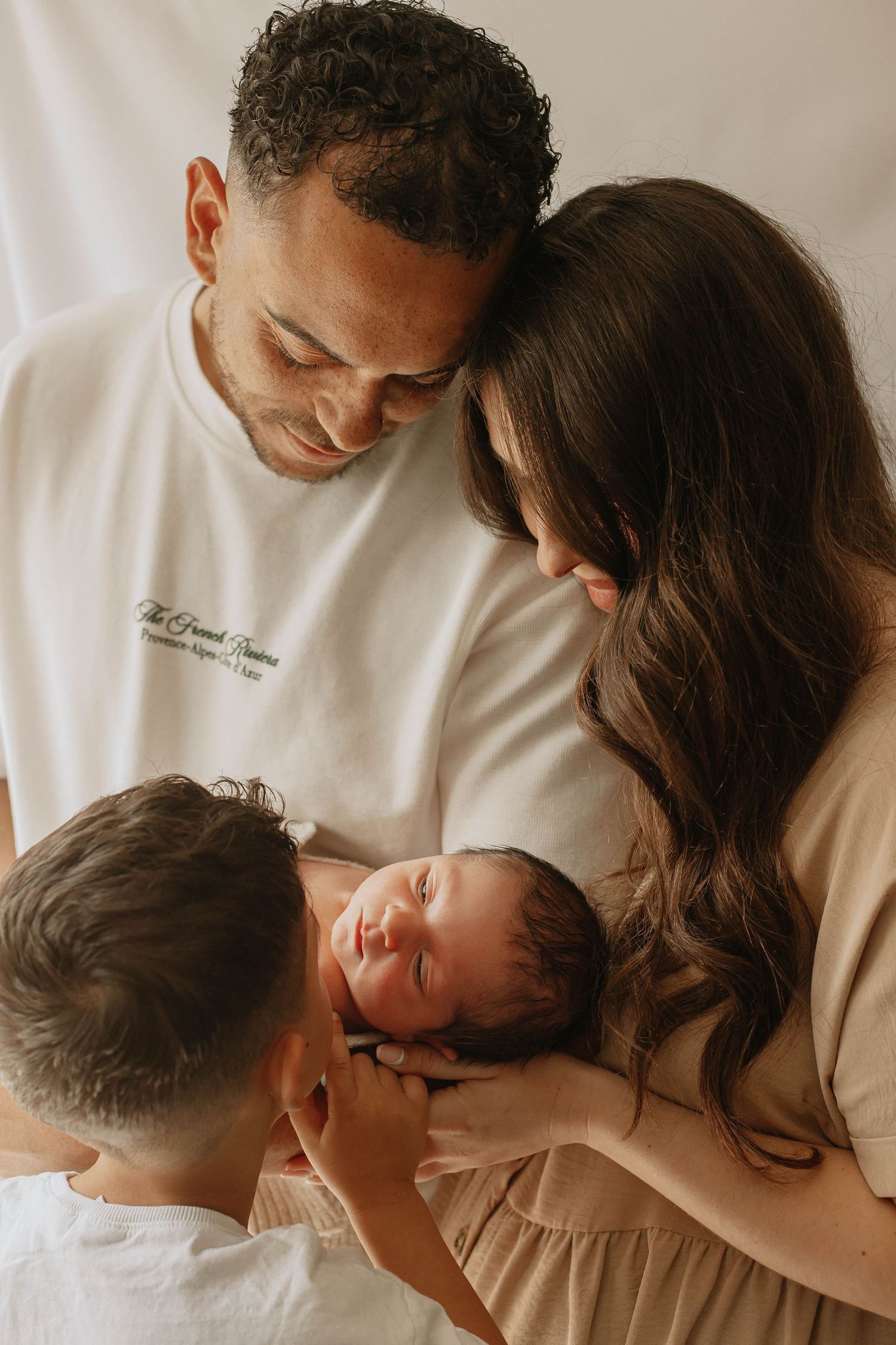 Family of four in newborn in home photoshoot in Ashford Kent