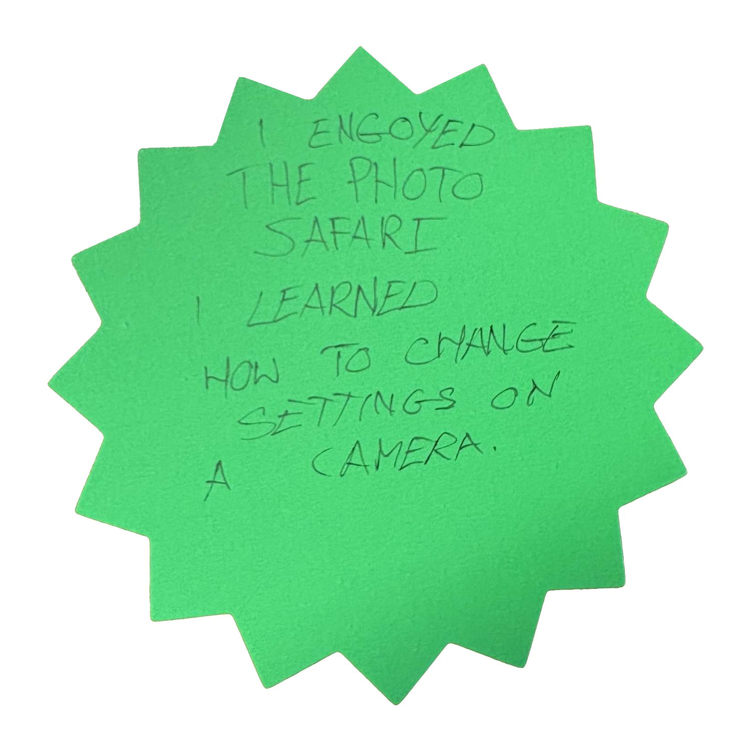 Three bright green star-shaped sticky notes with handwritten notes about camera settings.