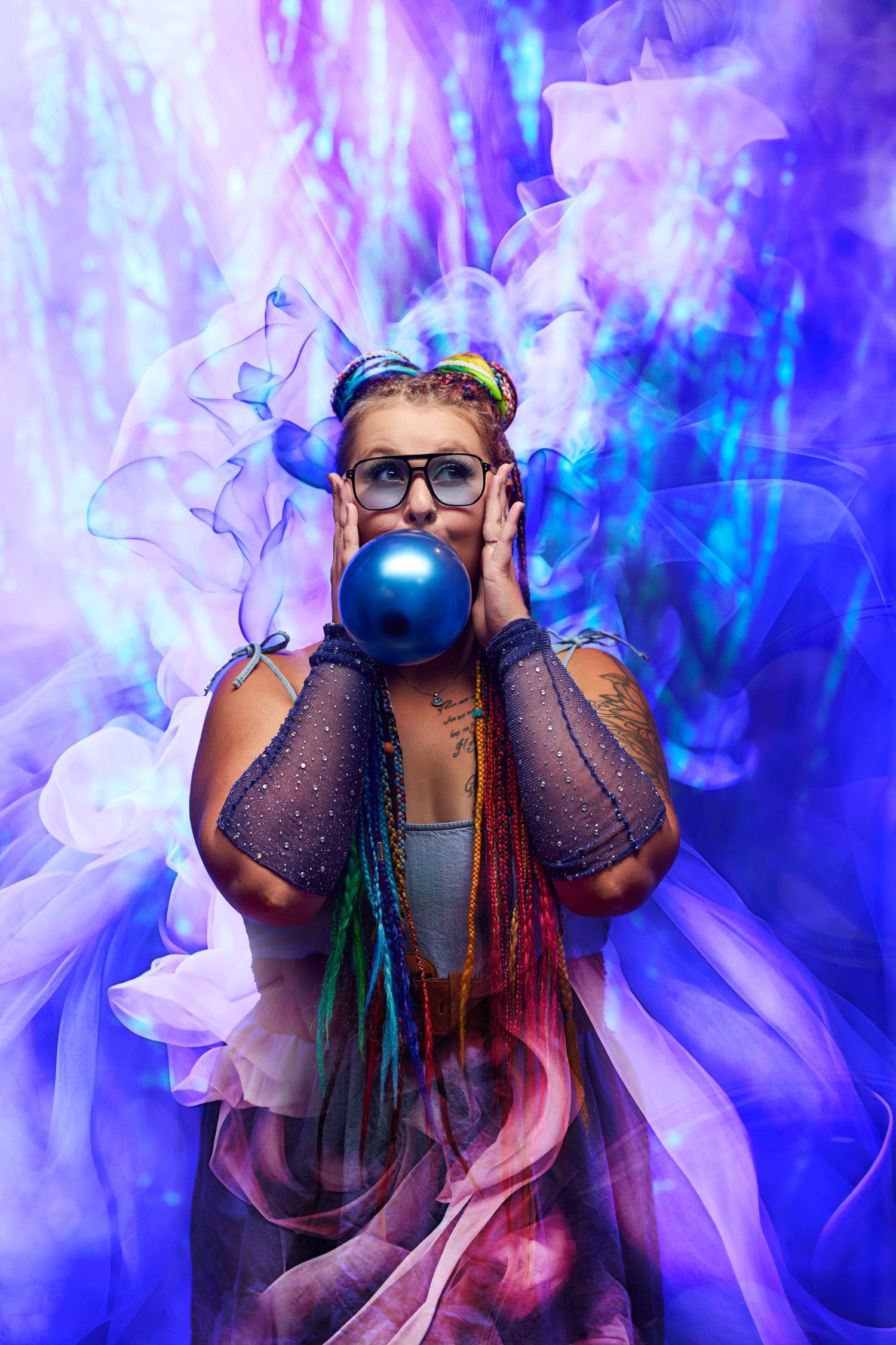 Artistic portrait series with colorful smoke effects in purple and blue tones against dark background.