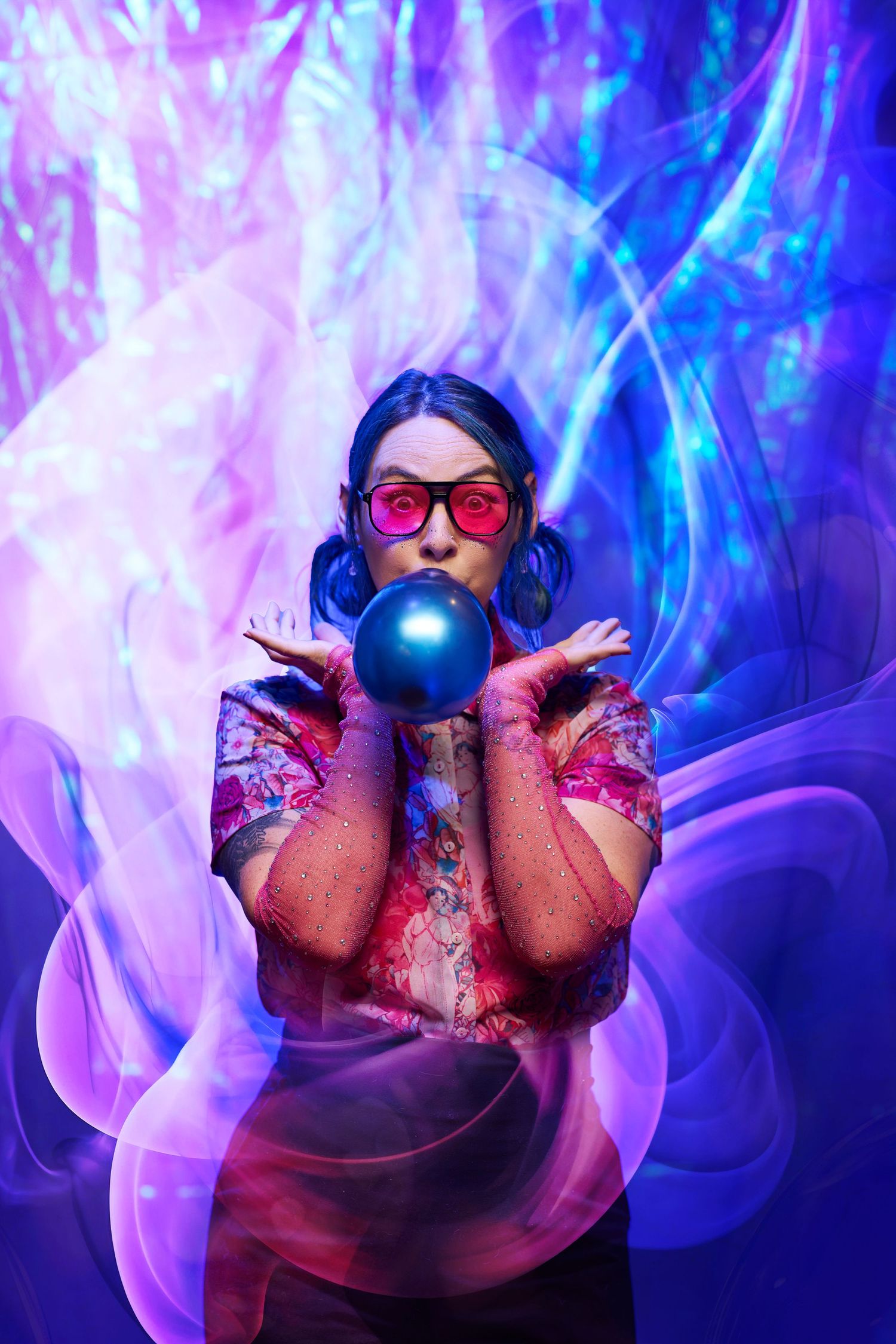 Creative purple and blue light painting photography with swirling luminous effects and glowing orbs creates ethereal atmosphere.