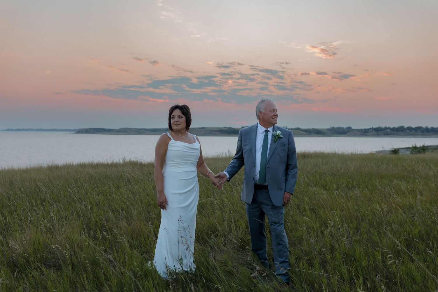 Bride and groom kissing at a bar in Garrison North Dakota before their wedding reception photography session