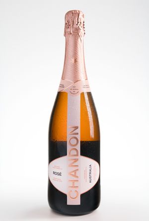Elegant rose gold champagne bottles lined up against a white background.