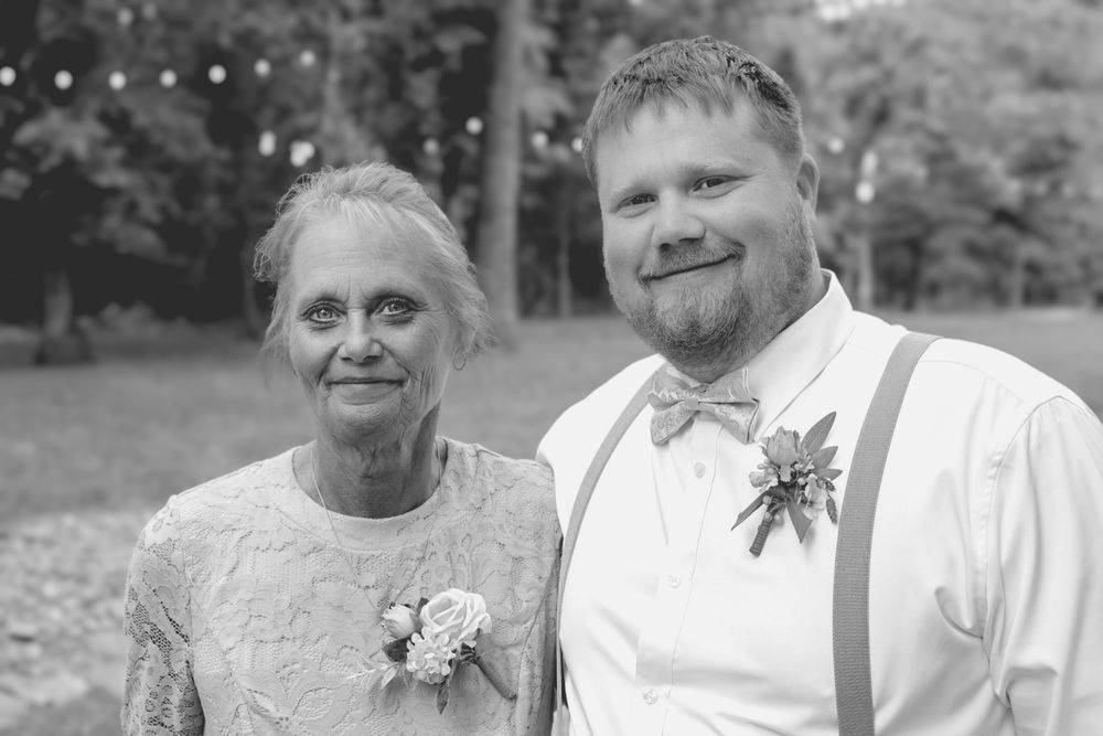 A black and white wedding photos showing couples embracing and sharing joyful moments together Country Manor in Rogers Arkansas