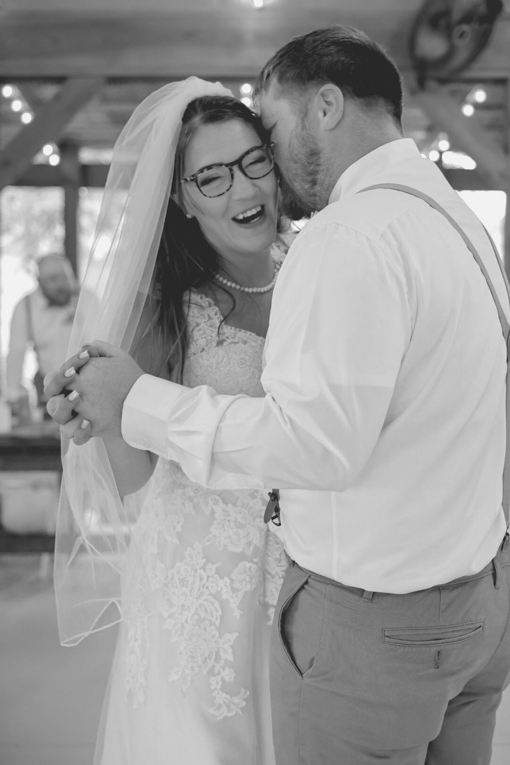 A romantic sequence of black and white photos showing a couple dancing and embracing at their wedding celebration.