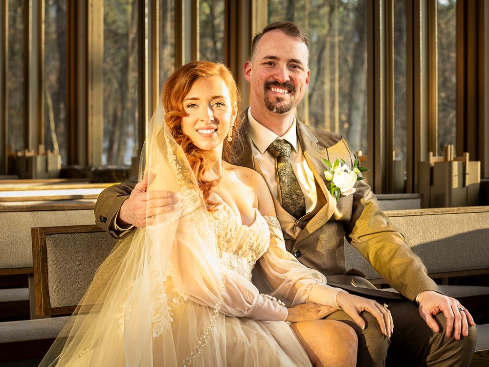 Bride and groom share intimate moments in warm sunlit forest setting.
