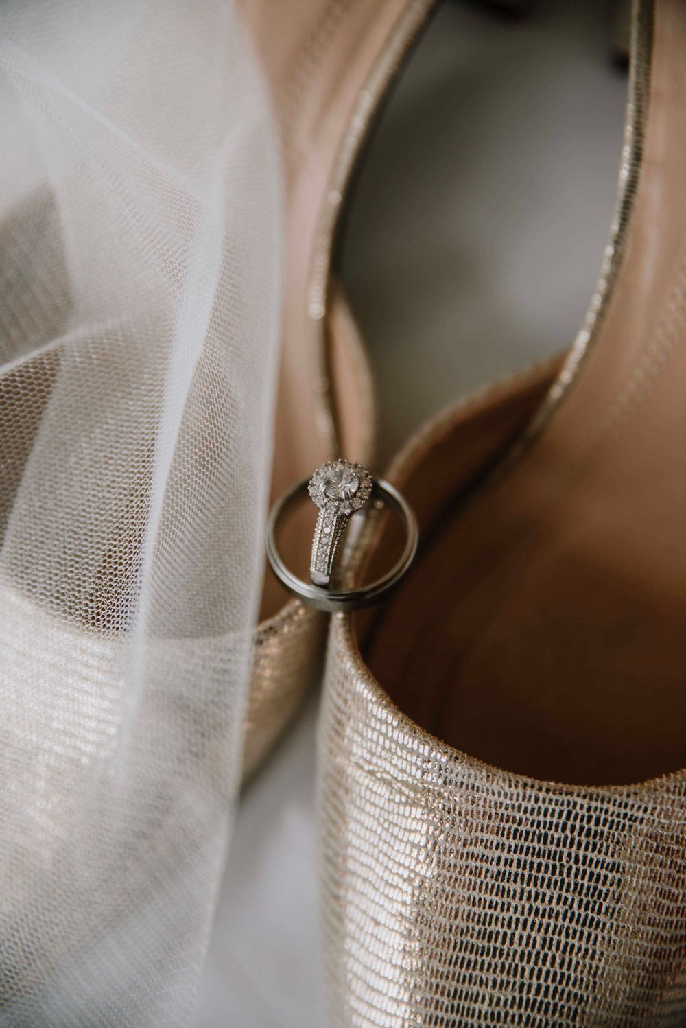 Elegant portrait of wedding shoes and wedding rings.