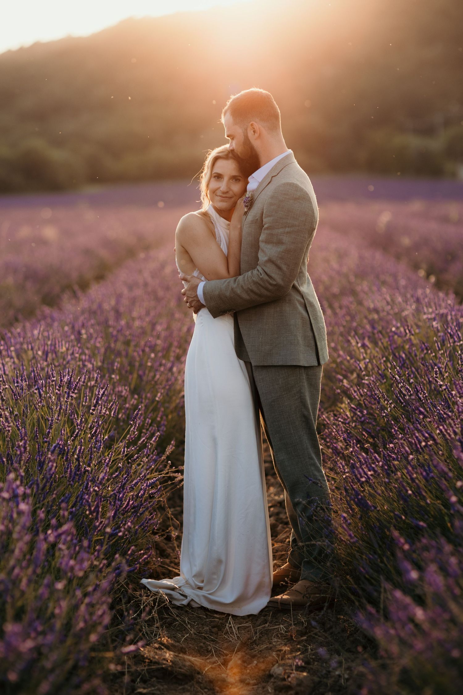 A tender autumn embrace captured during a wedding photoshoot with fall foliage.