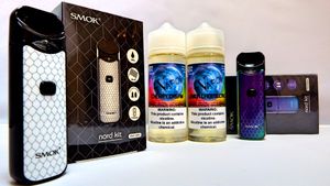 Assorted vaping devices and e-liquid bottles displayed with product packaging.
