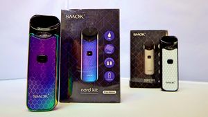 SMOK vaping device boxes and products laid out in a marketing display arrangement.