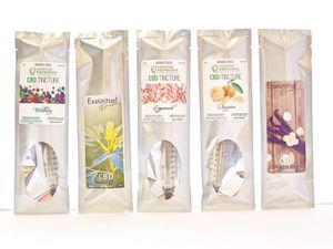 Display of white retail packaging pouches for CBD and herbal tincture products.