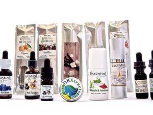 Various CBD and essential oil product bottles arranged in a row against white background.
