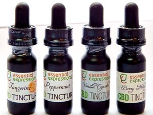 Series of amber glass tincture bottles with black dropper caps and herbal product labels.