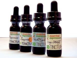 Line of dark glass dropper bottles with Essential Expressions CBD tincture labels.