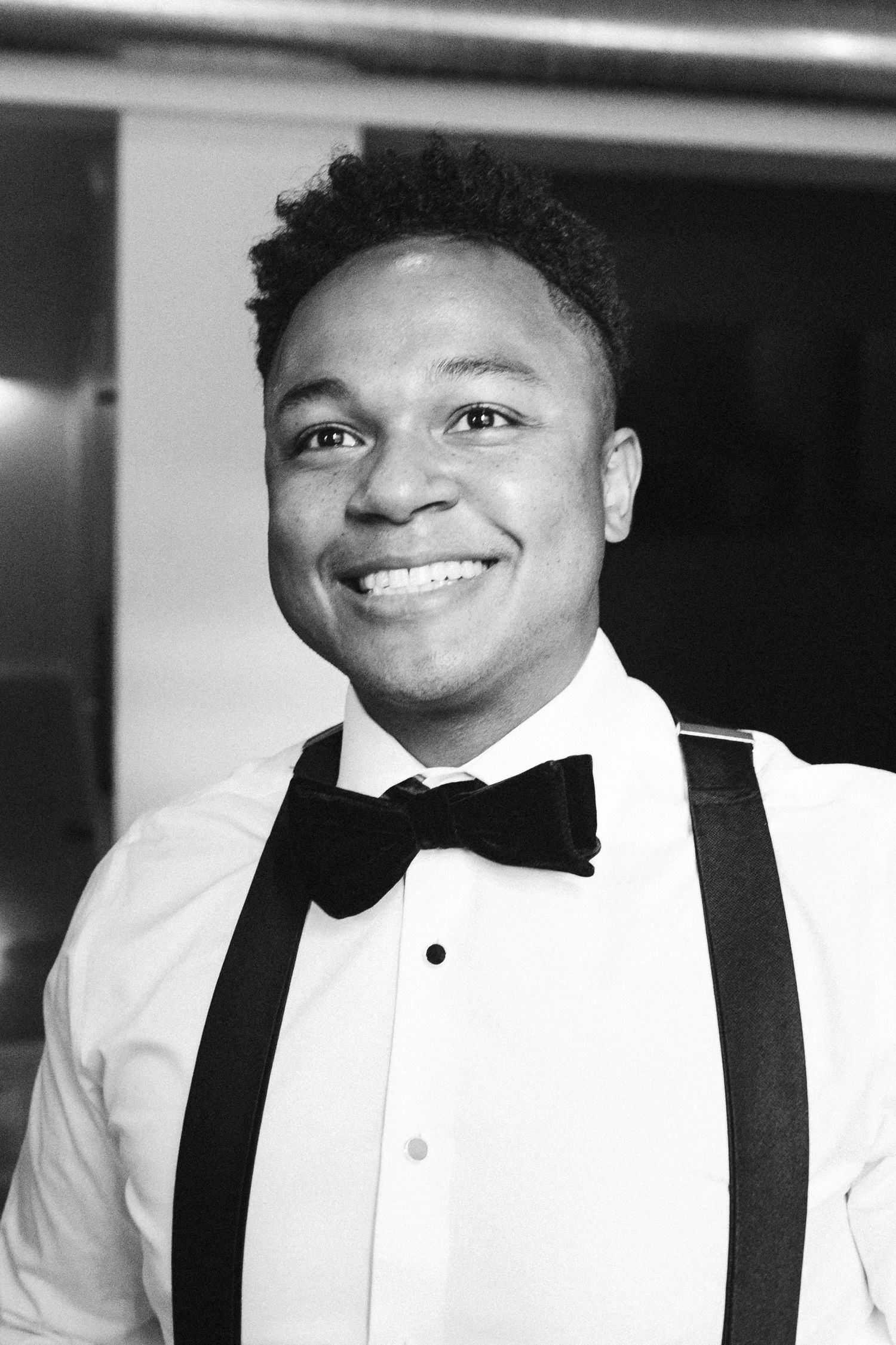 Sequence of joyful expressions in formal black bow tie and white tuxedo.