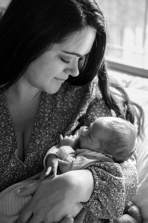 Black and white series capturing gentle moments with sleeping newborn.
