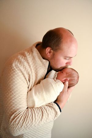 Series showing adult in cream sweater sharing tender moments with newborn.