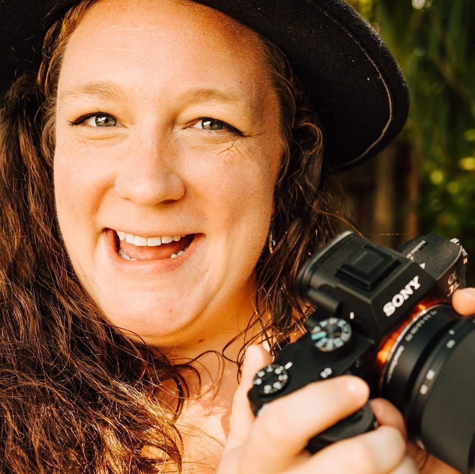 Candid, casual self-portrait of Aliza taken outdoors with soft natural light, showcasing the artist behind Portraits by Aliza.