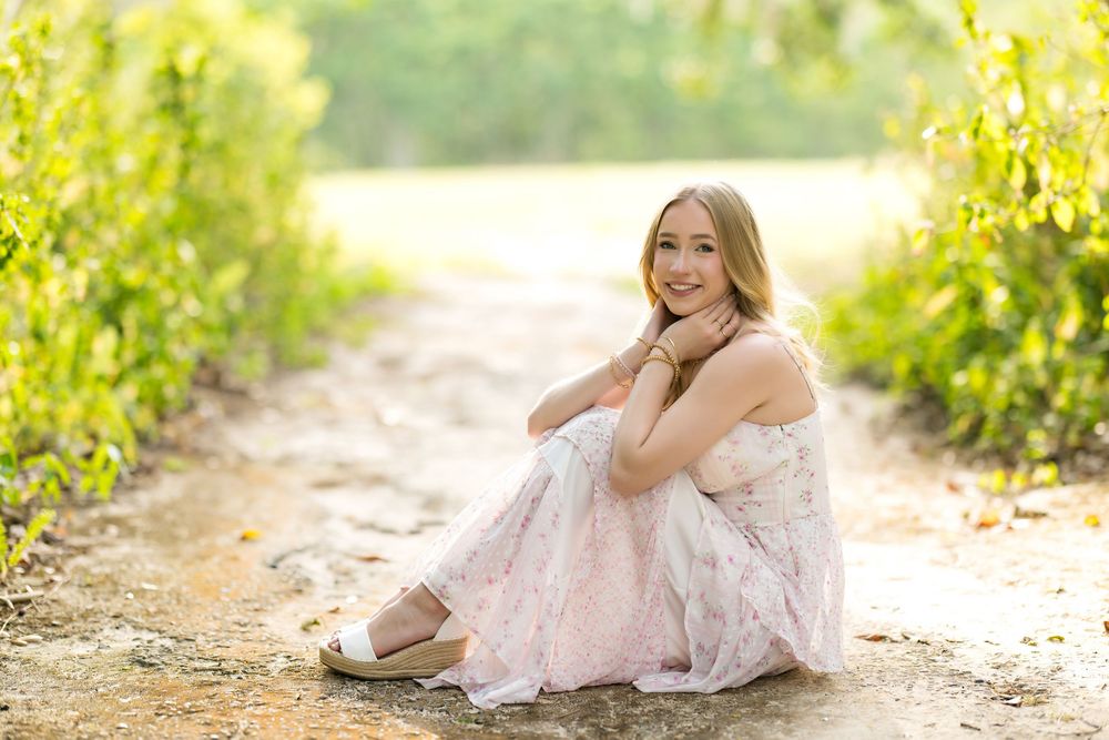A peaceful portrait in a blush dress and lace shawl between vineyard rows at sunset.