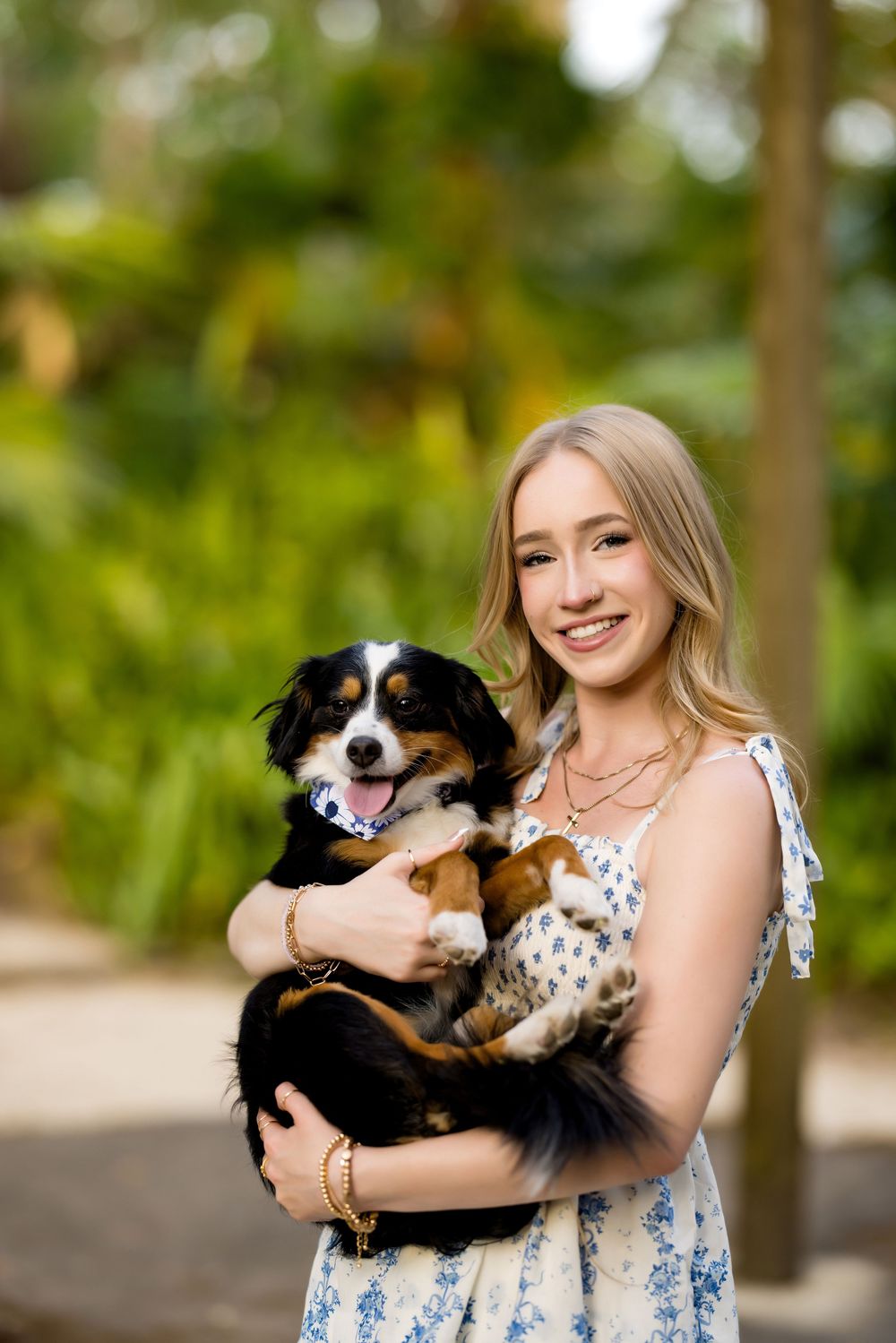 Sweet portrait with a happy black and white dog in a garden setting.