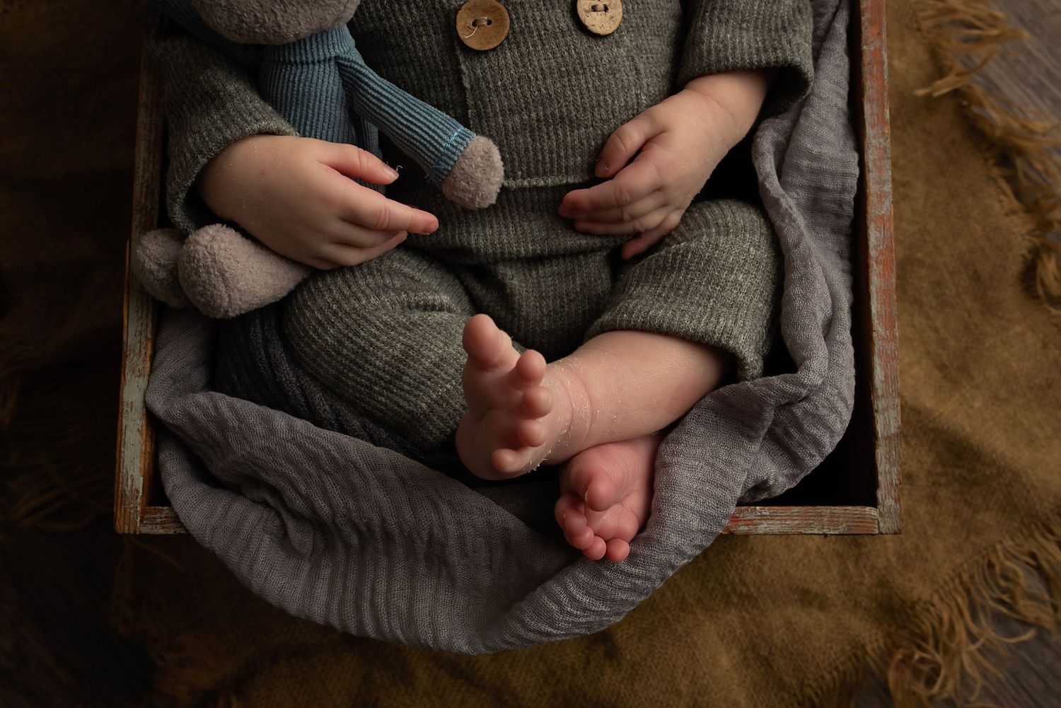 Close-up details of a cozy gray knit sweater showing texture and buttons.