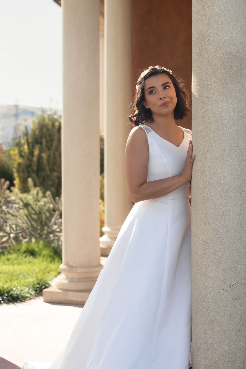 Classic bridal portrait of bride in white gown taken in natural light at an outdoor venue