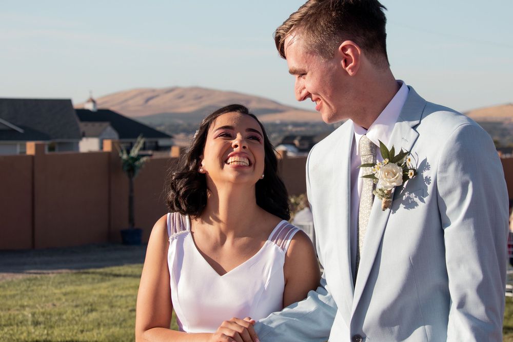 Newly married couple walking together after ceremony, laughing and soaking in the moment