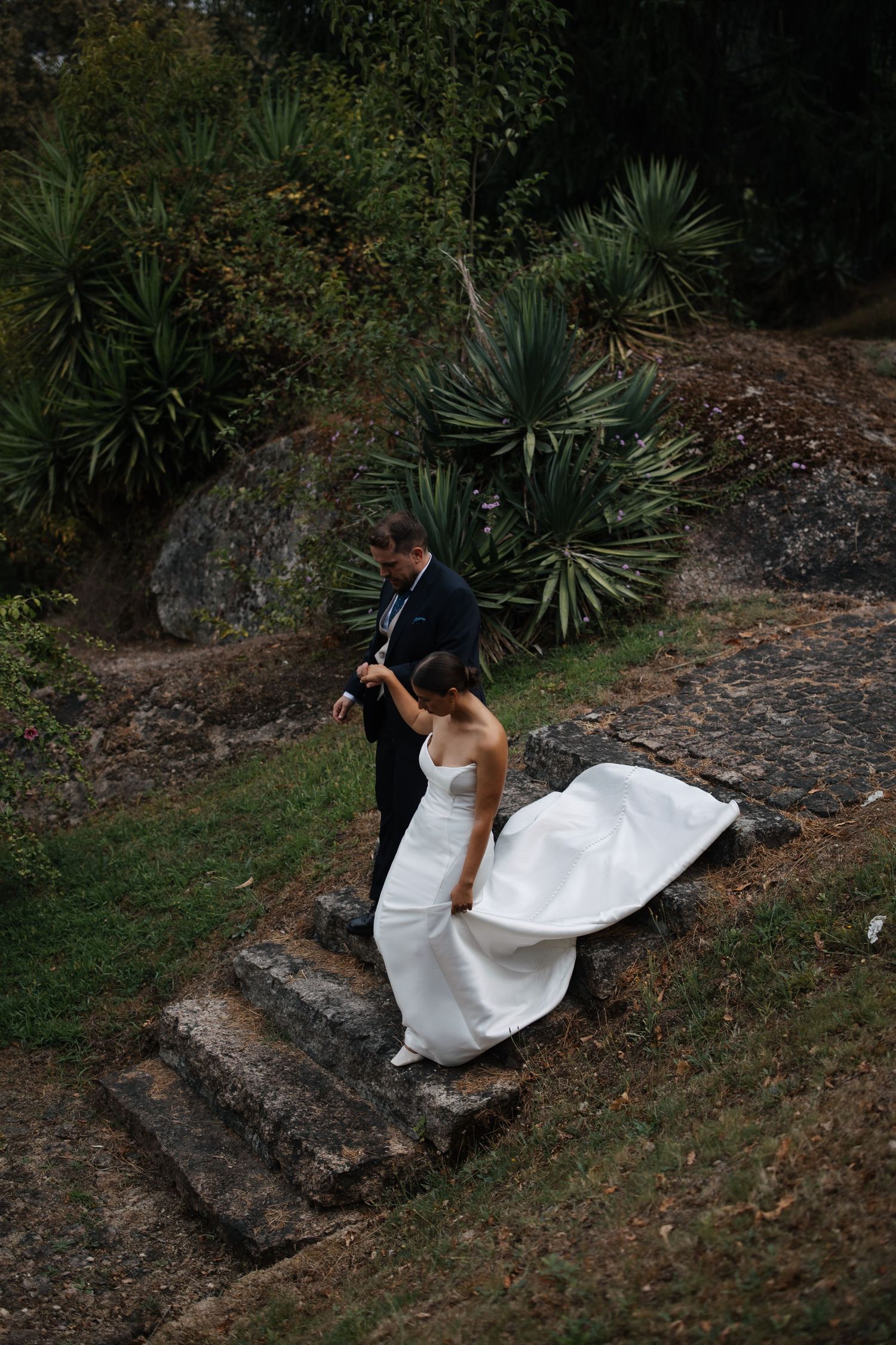 A couple shares their first dance as newlyweds under an elegant white gazebo decorated with chandeliers.