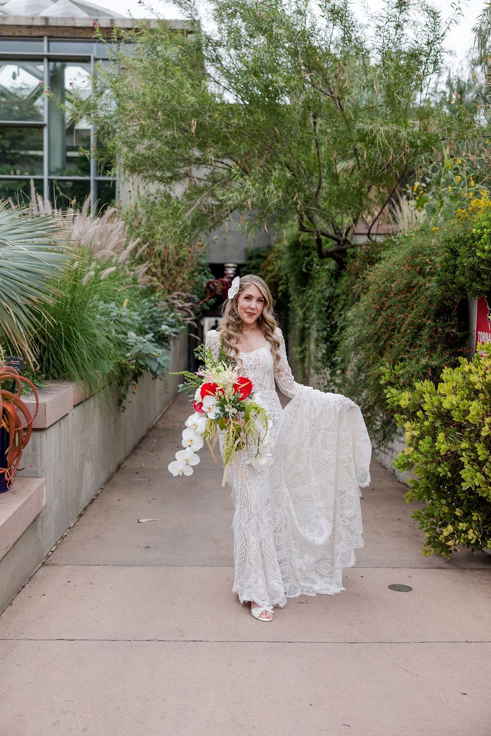 A series of photos showing a white lace wedding dress flowing gracefully along a garden pathway with ornamental grasses.