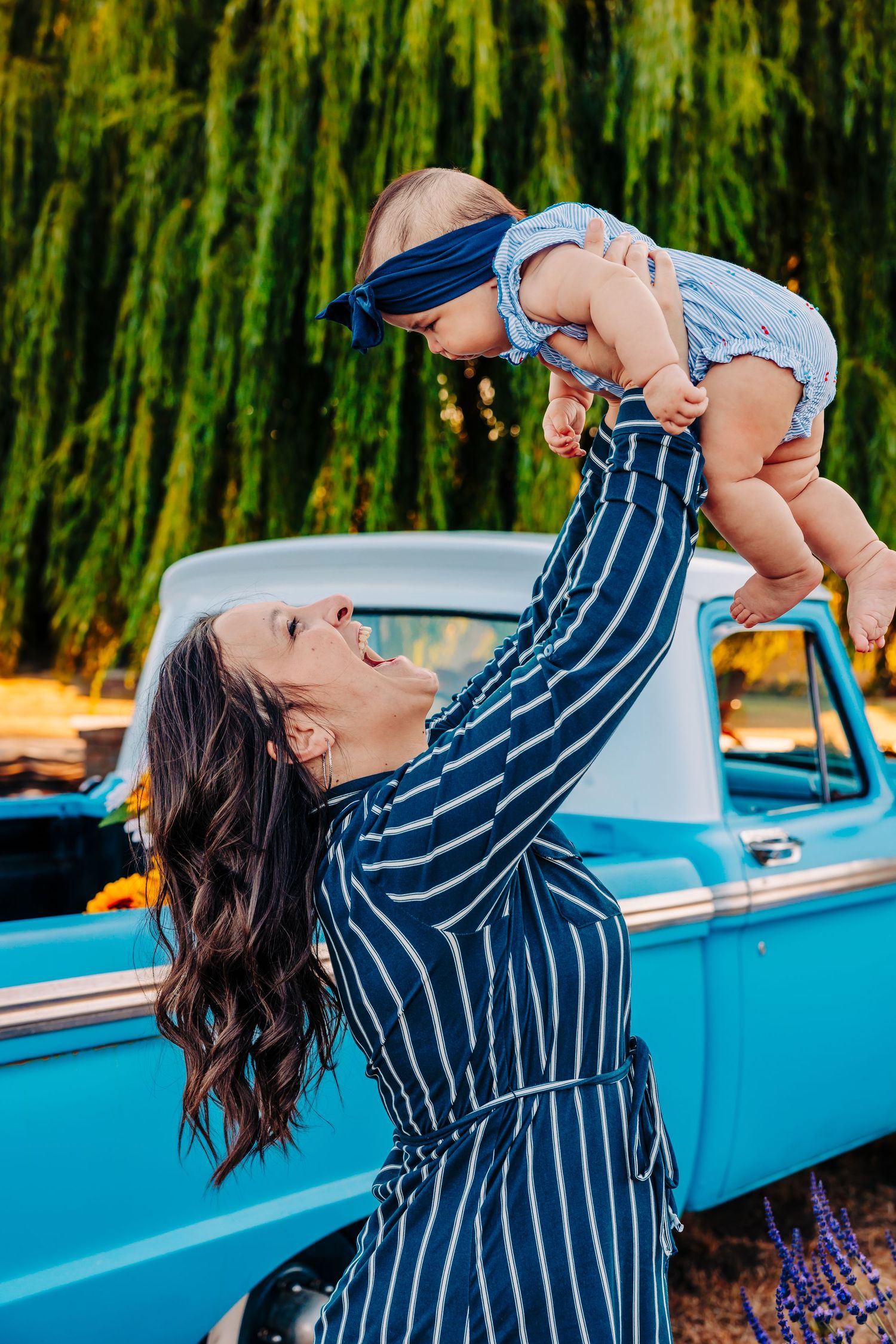 A series of three photos showing a person in a striped shirt lifting a baby against a bright blue classic car backdrop.