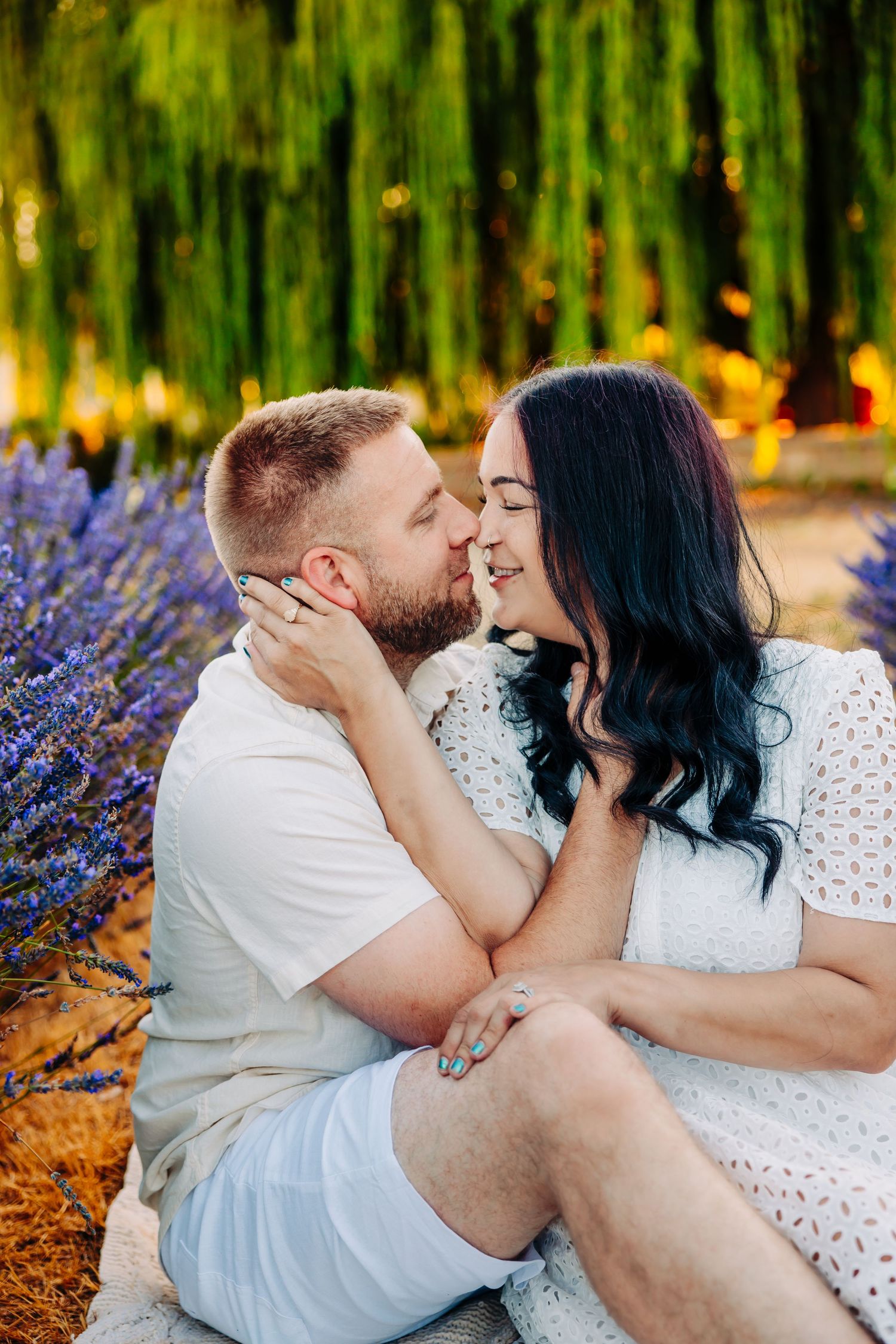 Romantic couple sharing tender moments in a garden with lavender flowers and autumn leaves.