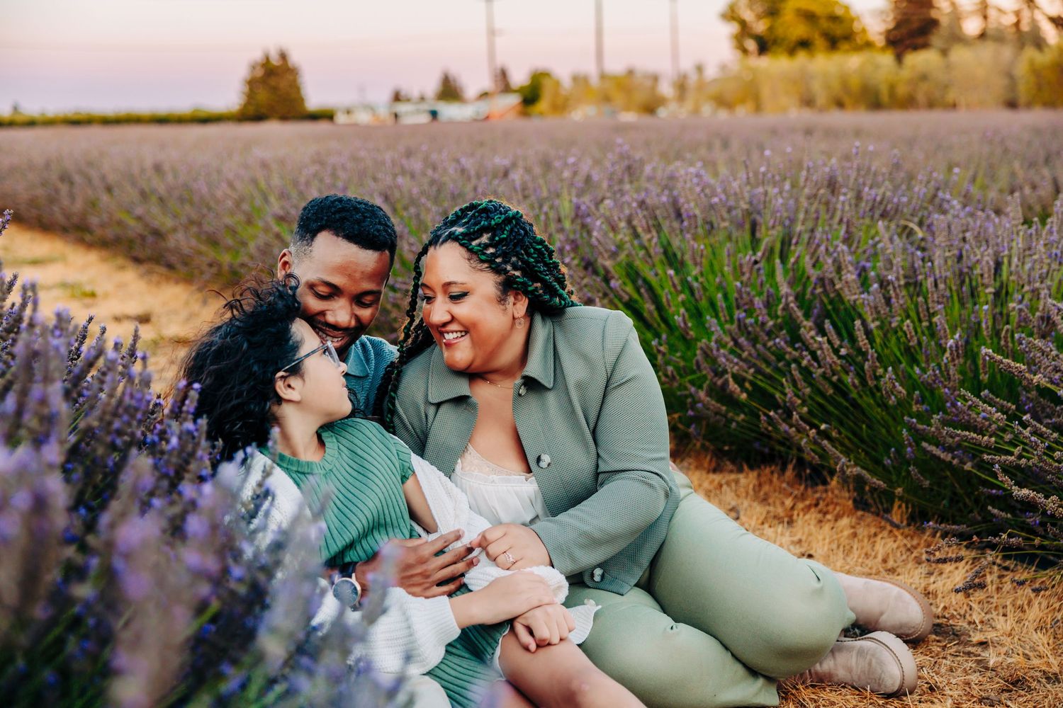 A joyful family moment captured in a blooming lavender field during golden hour.