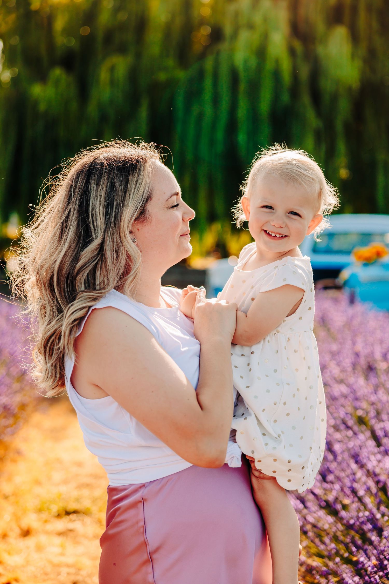 A joyful moment captured in a lavender field with warm sunlight and natural expressions of happiness.