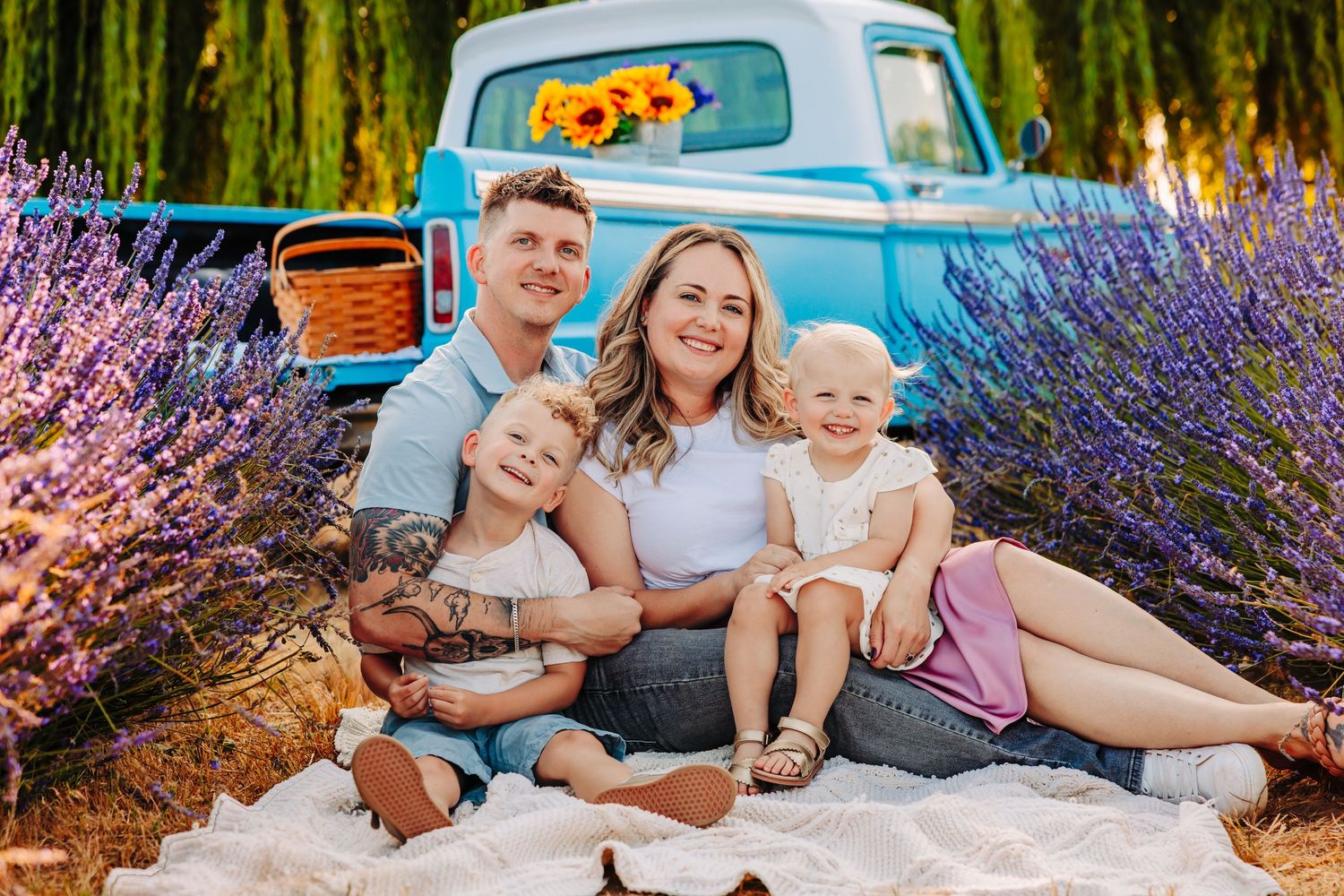 Family having a picnic and sharing intimate moments among lavender flowers on a summer evening.