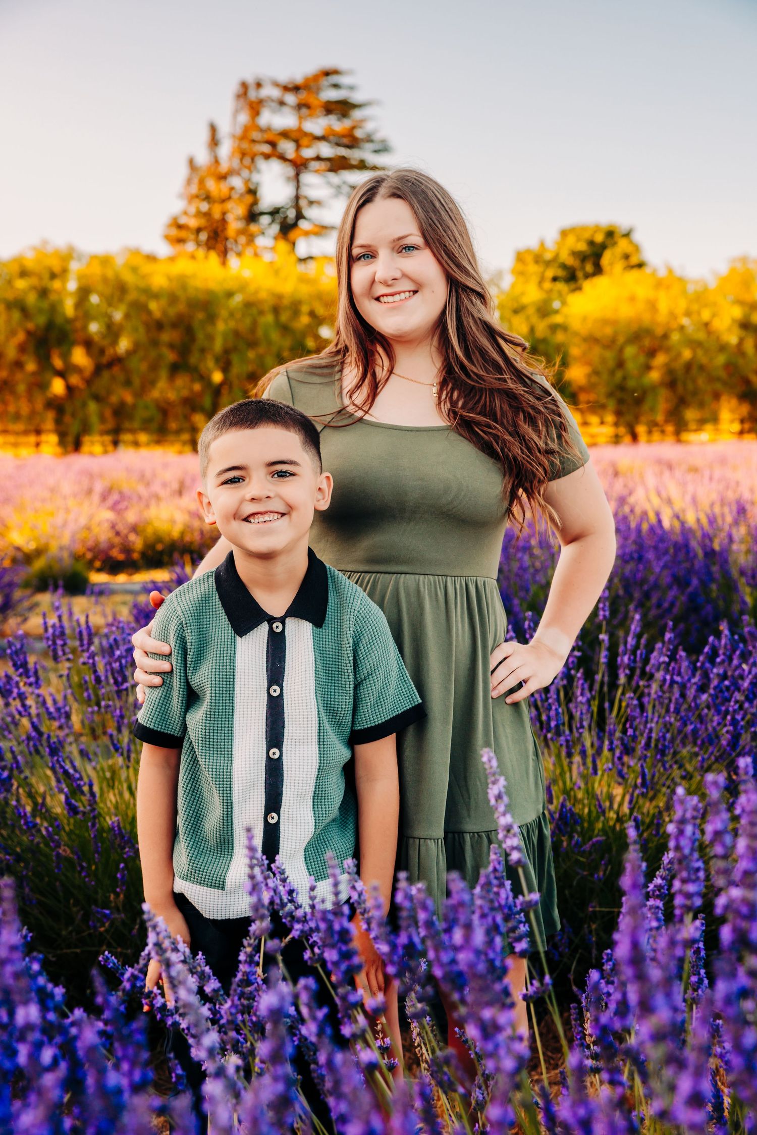 A joyful portrait session in a vibrant purple lupine flower field at golden hour.