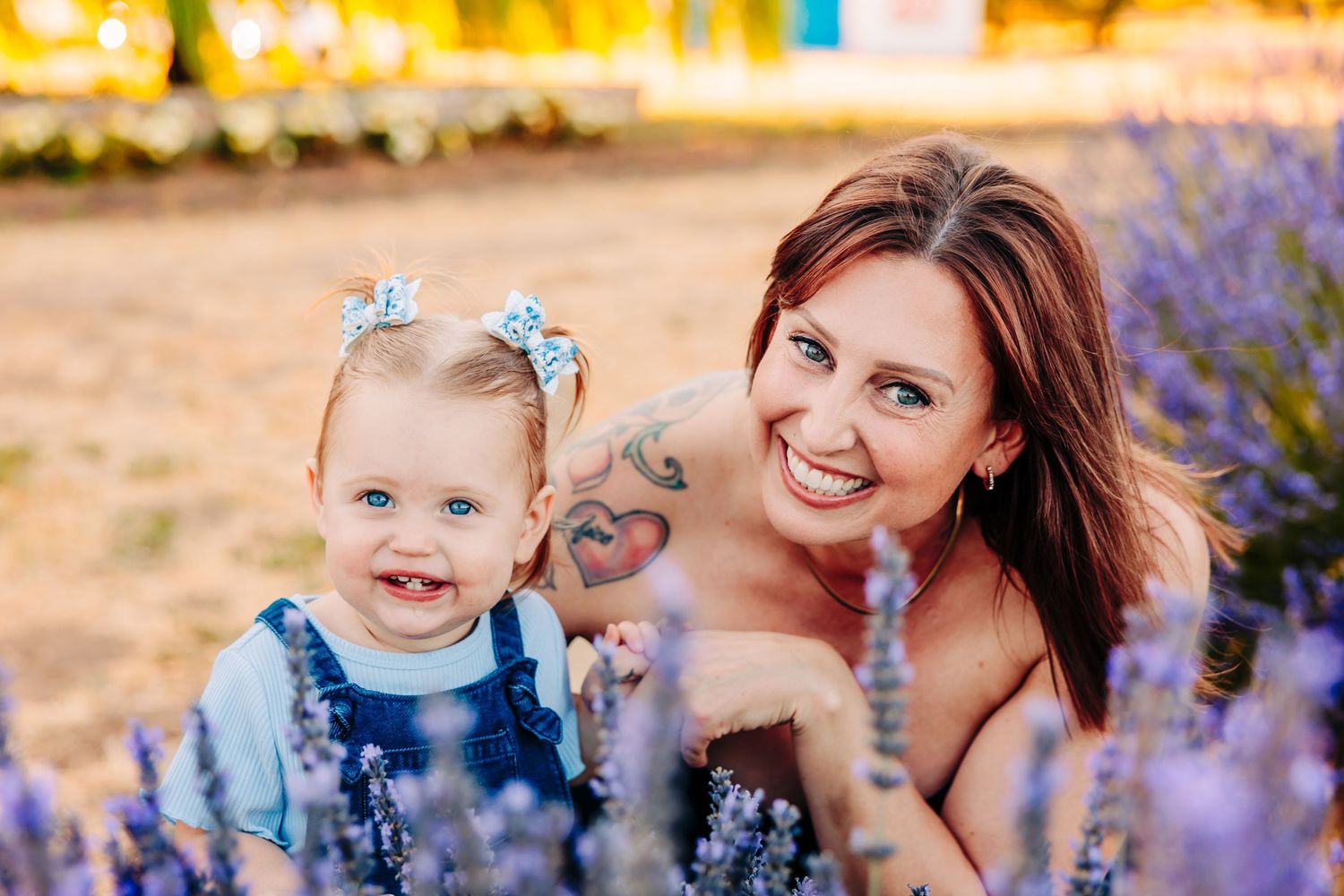 A joyful moment captured in a field of purple wildflowers during golden hour.