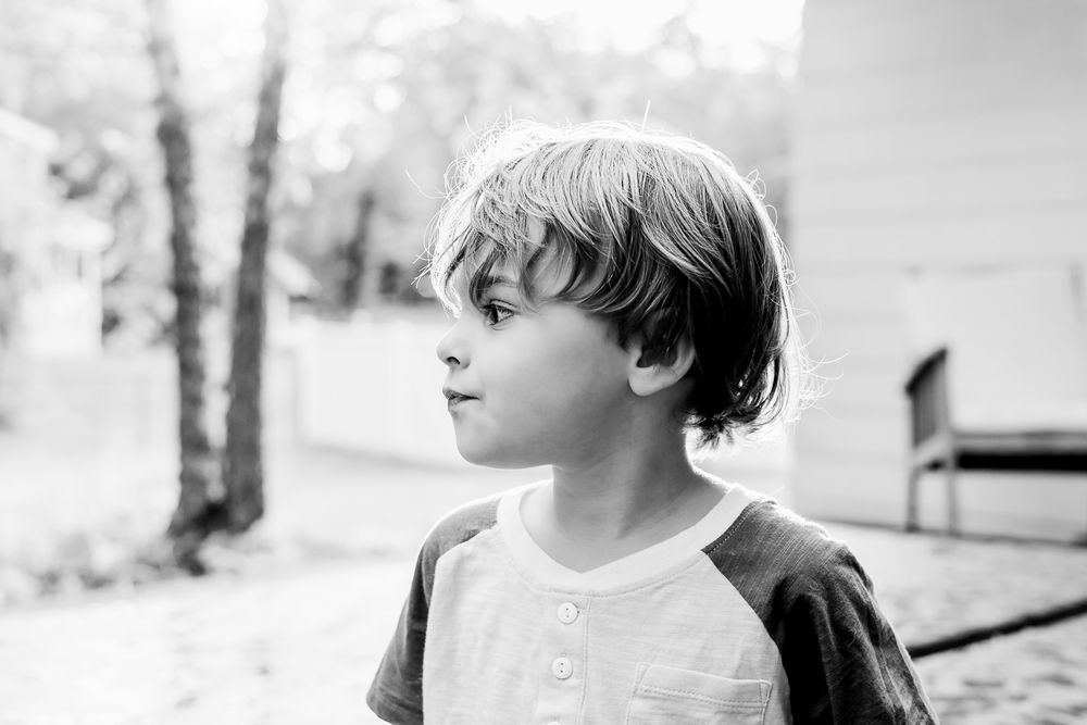 Black and white close-up portraits of a young child showing various expressions.