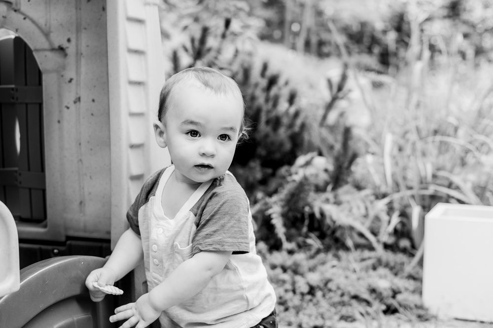 Black and white series showing a toddler's different facial expressions and poses.