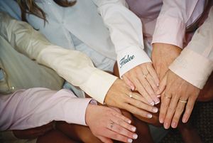 Close-up sequence of hands showing wedding rings at a celebration.