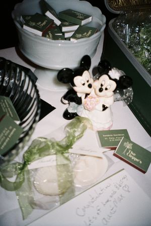 Mickey Mouse plush toys and decorative items on a white surface.