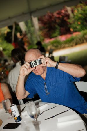 Someone taking photos with a vintage camera at an outdoor event.