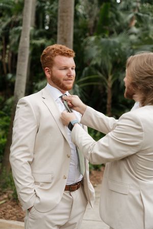 A series of candid moments showing a couple in white attire sharing playful interactions in a garden setting.