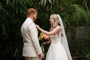 First look wedding sequence in a romantic palm garden setting.